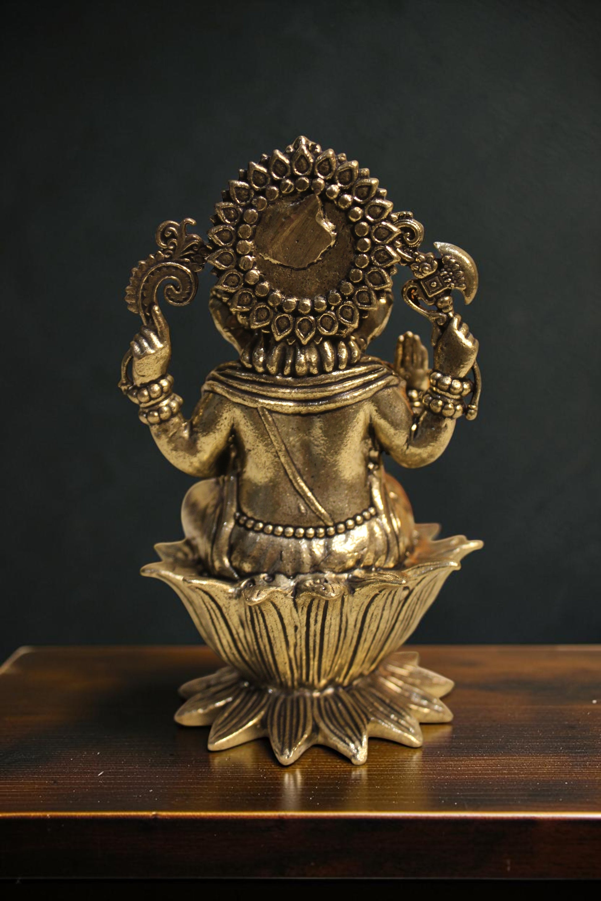 Rigvedaa™ Brass Lord Ganesha idol seated on a lotus pedestal, 4-inch, golden finish, holding symbolic items.