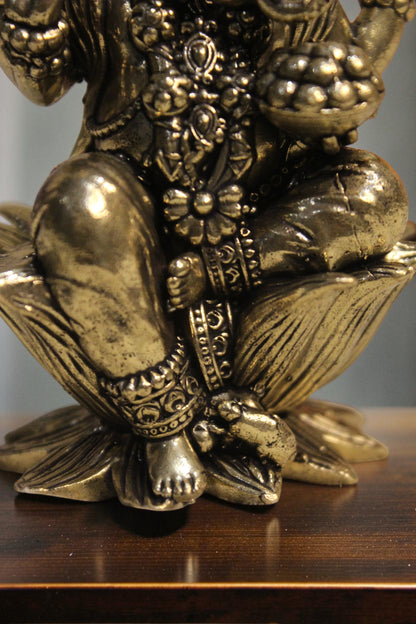 Rigvedaa™ brass Lord Ganesha idol seated on a lotus pedestal, 4-inch golden finish, intricate details, right trunk.