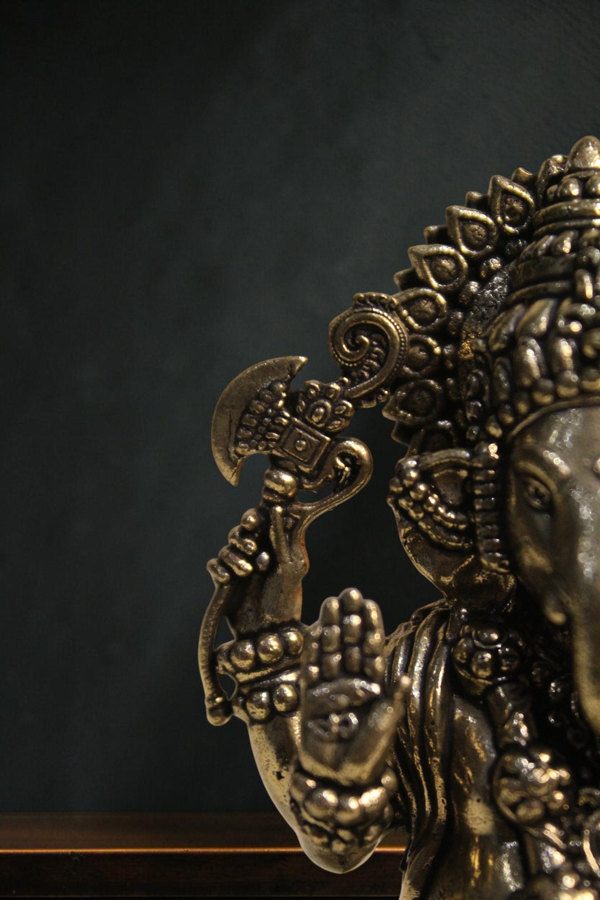 Rigvedaa™ brass Lord Ganesha idol seated on a lotus, holding an axe and offering blessings. 4-inch golden sculpture.