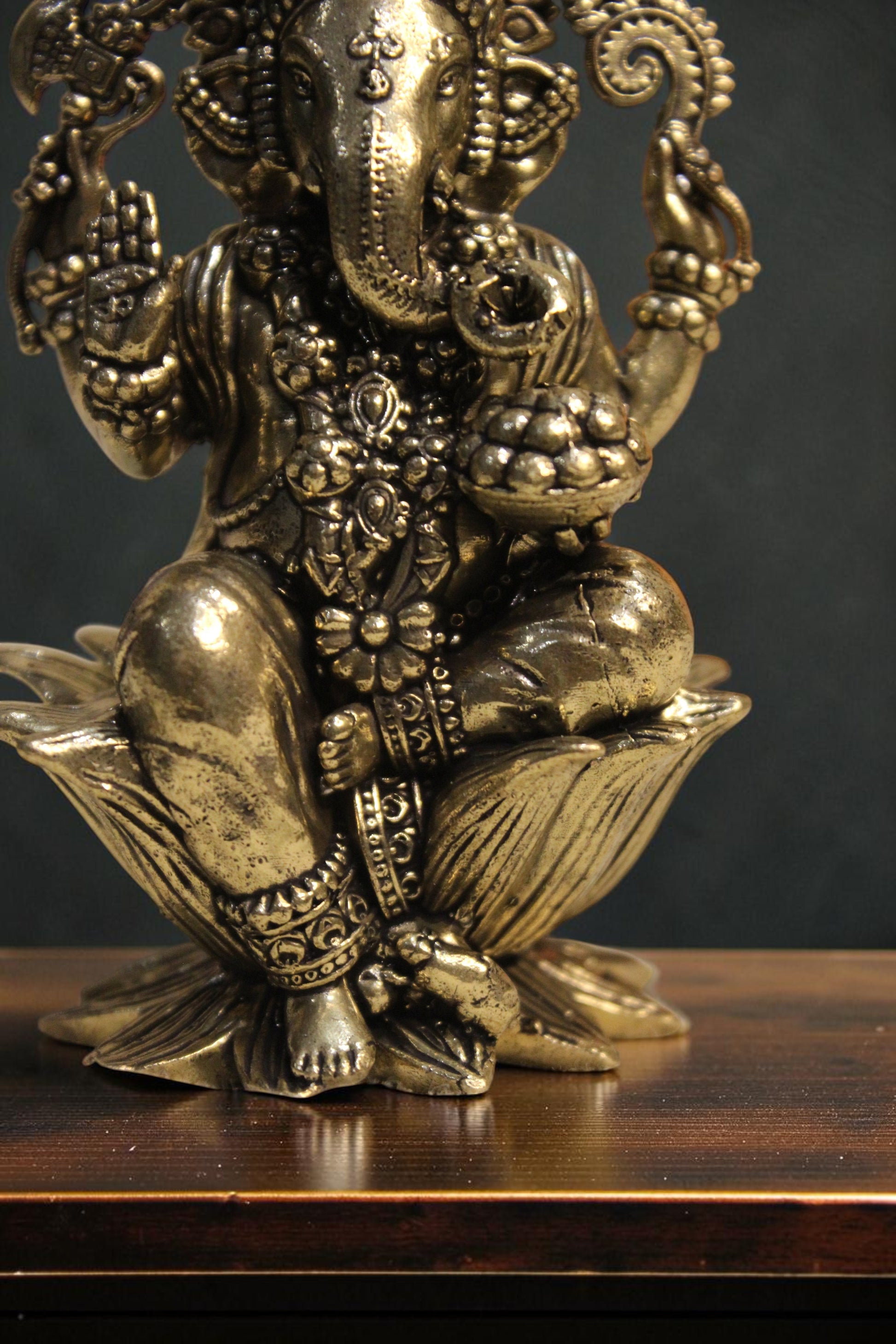 Rigvedaa™ Brass Lord Ganesha idol seated on a lotus pedestal, 4-inch golden sculpture for wisdom and prosperity.