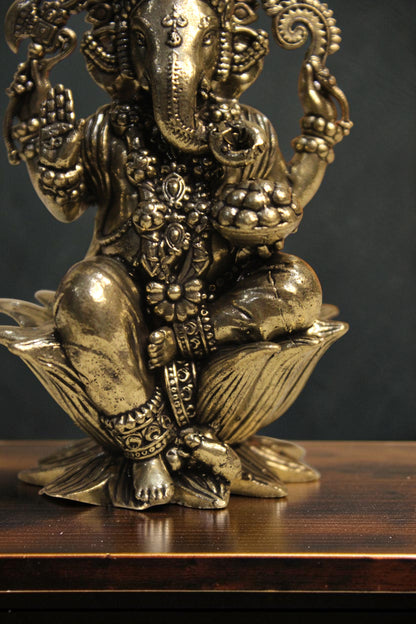 Rigvedaa™ Brass Lord Ganesha idol seated on a lotus pedestal, 4-inch golden sculpture for wisdom and prosperity.