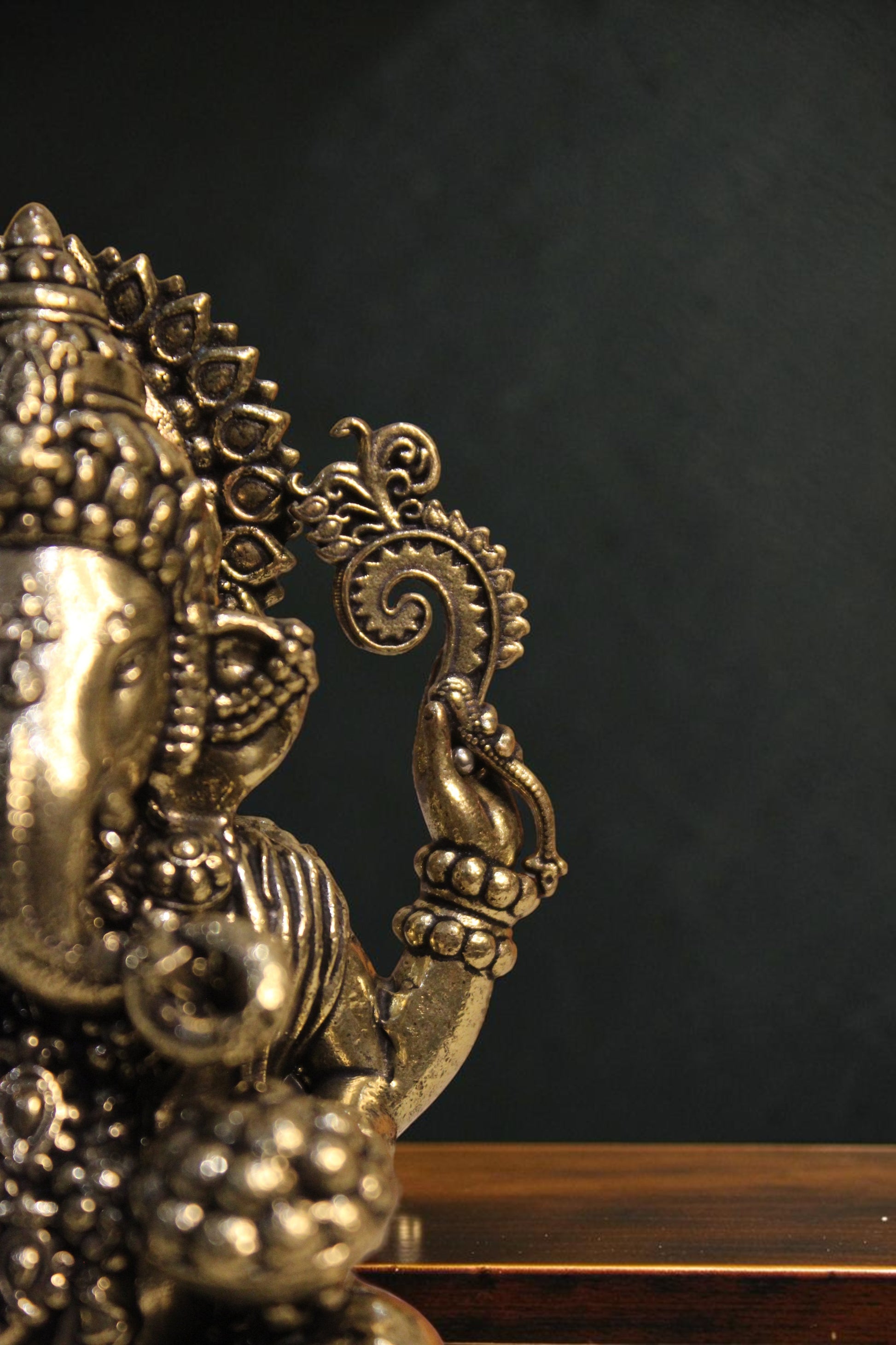 Rigvedaa™ brass Lord Ganesha idol seated on a lotus, 4-inch, golden finish, intricate details, right trunk.