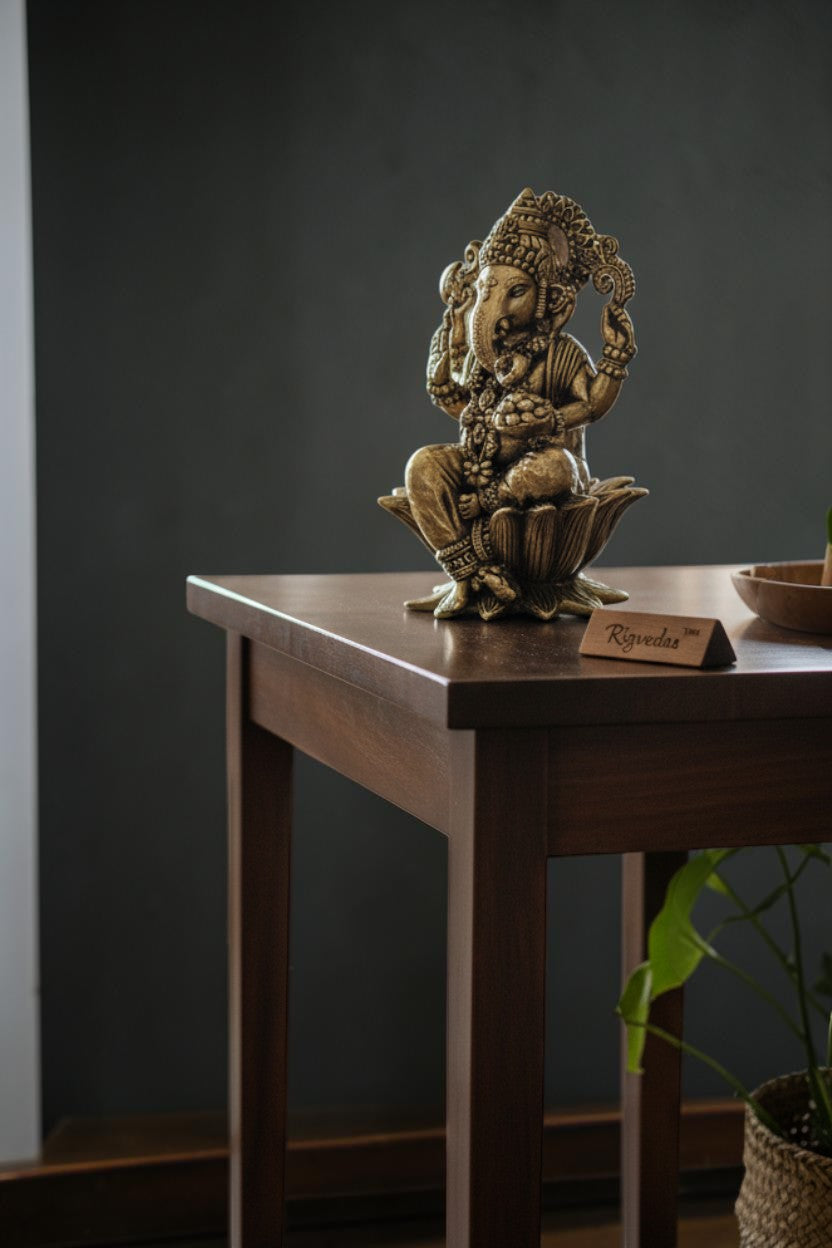 Rigvedaa™ brass Lord Ganesha idol seated on a lotus, 4-inch golden divine sculpture for wisdom and prosperity.
