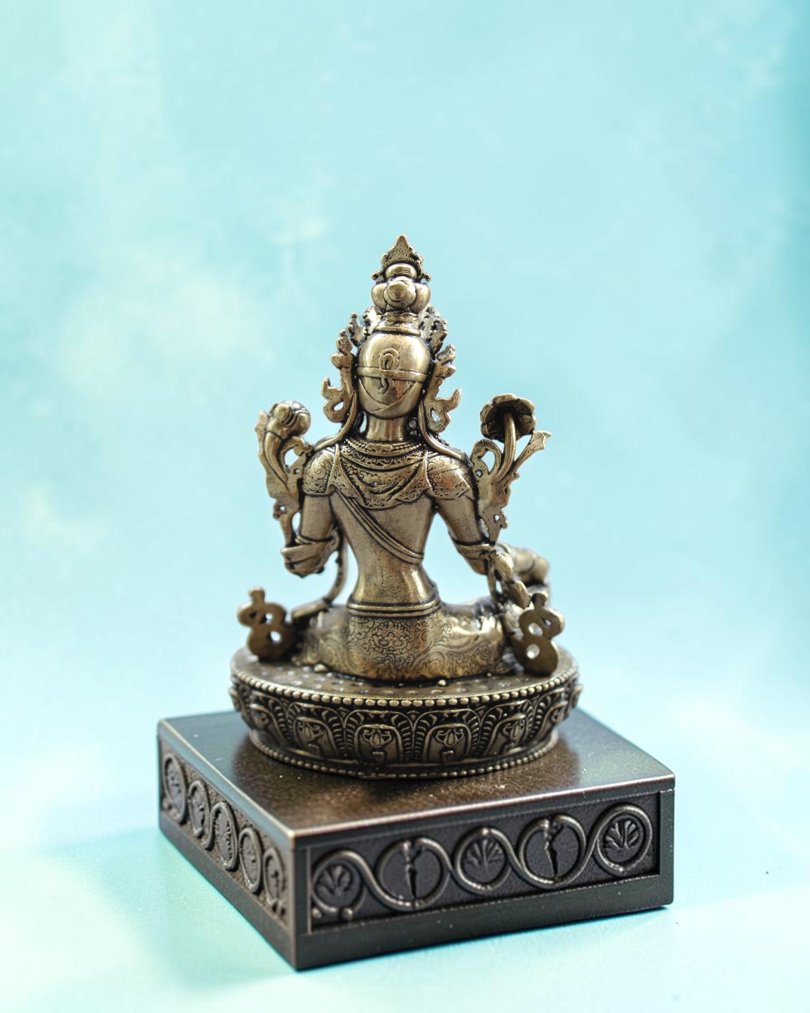 Rigvedaa™ brass statue of seated Goddess Tara in Varada Mudra on lotus throne, holding lotus flower.