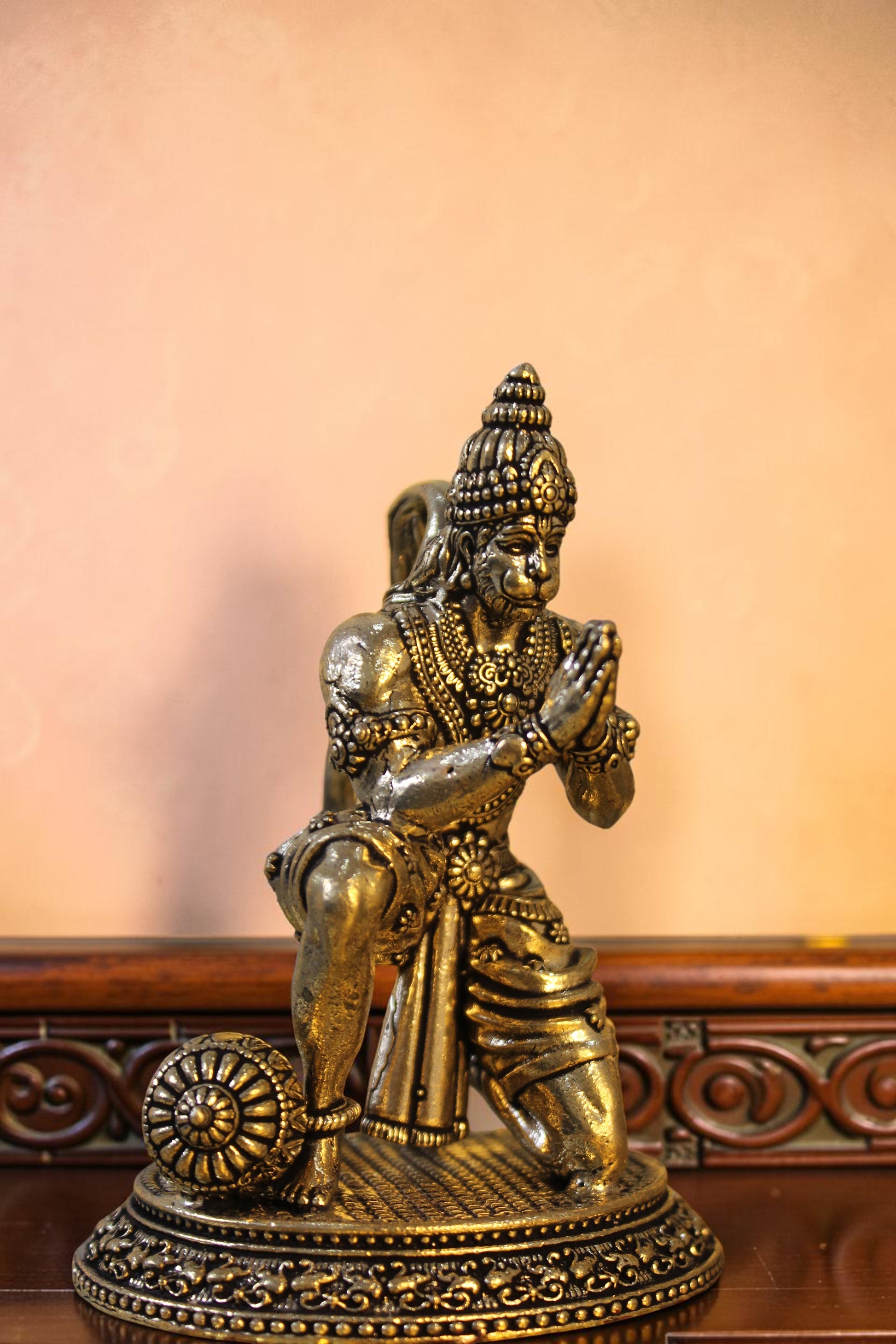 Rigvedaa™ antique brass Hanuman idol, kneeling with hands in prayer, detailed costume and mace at side. 7 inch.