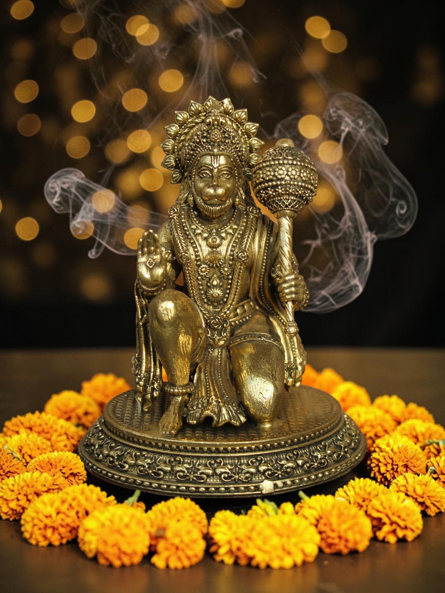 Rigvedaa™ brass Lord Hanuman idol in Ashirwad mudra, featuring intricate carvings and antique gold finish on marigolds.