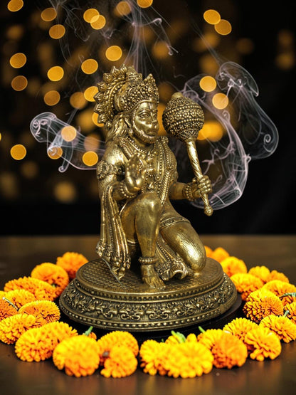 Rigvedaa™ brass Lord Hanuman idol in Ashirwad mudra, seated on an ornate base with a mace, surrounded by marigold flowers