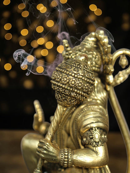 Rigvedaa™ brass Lord Hanuman idol in Ashirwad mudra with detailed mace, featuring antique gold finish and incense smoke