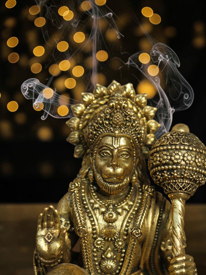 Rigvedaa™ brass Lord Hanuman idol in Ashirwad mudra with detailed antique gold finish and sacred mace against bokeh