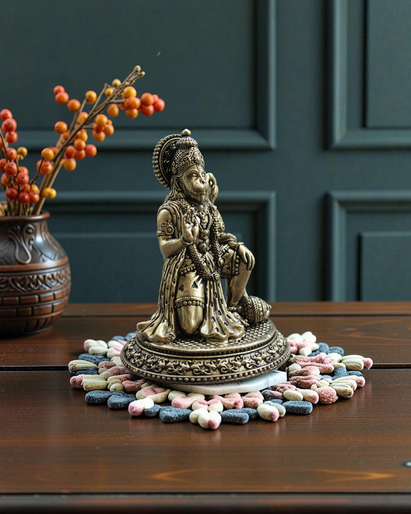 Rigvedaa™ Brass Hanuman Ji statue in blessing pose, seated with mace, detailed traditional attire and warm golden patina.