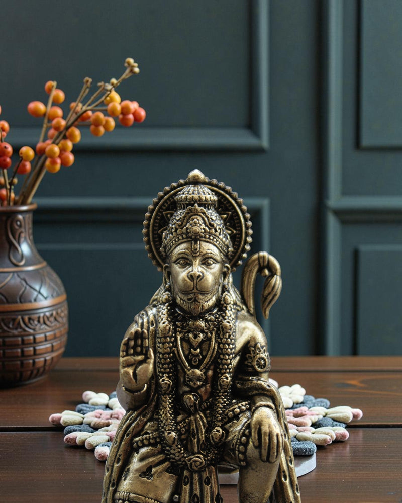 Rigvedaa™ brass Hanuman Ji statue in blessing pose, seated Bajrangbali with mace, intricate details, golden patina.