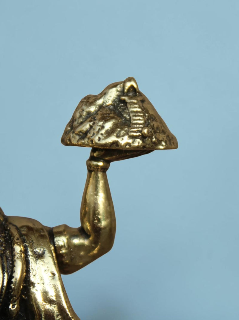 Rigvedaa™ brass Lord Hanuman idol detail showing him holding the Dronagiri mountain in a polished golden finish