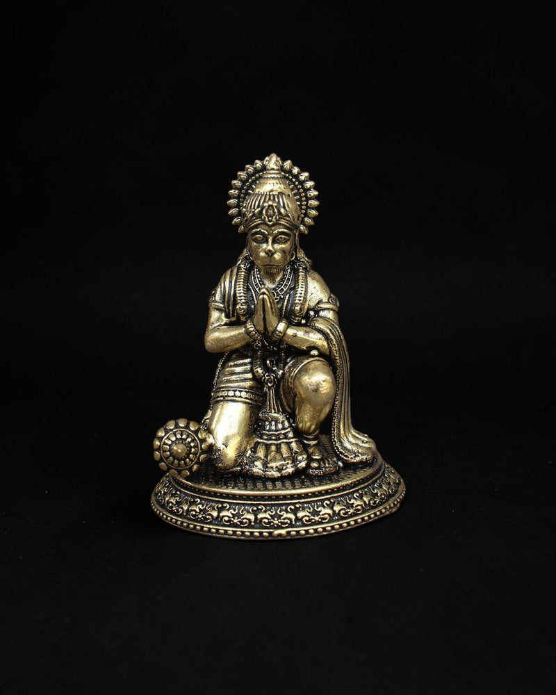 Rigvedaa™ handcrafted brass Hanuman statue in a kneeling prayer pose with intricate detailing and a warm golden patina.
