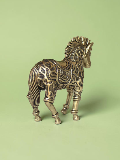 Rigvedaa™ decorative brass horse statue with intricate traditional relief patterns and a warm golden patina finish.