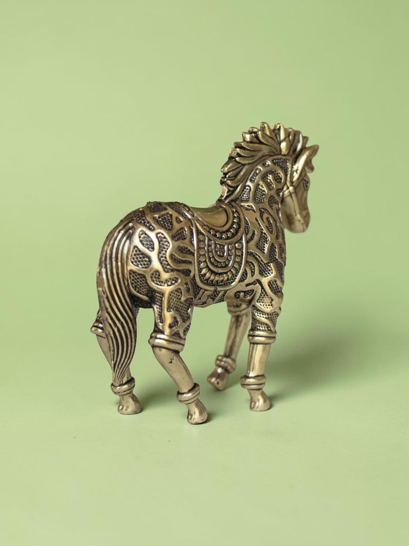 Rigvedaa™ decorative brass horse statue with intricate traditional relief patterns and a warm golden patina finish.