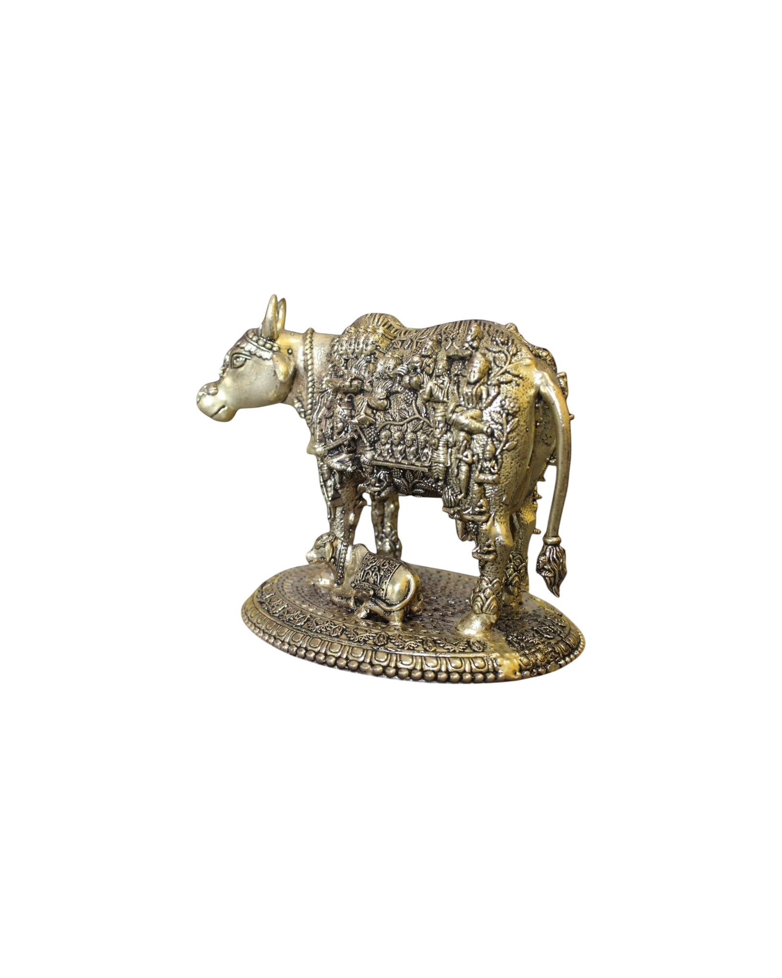 Rigvedaa™ brass Kamdhenu cow and calf idol with intricate engravings of Hindu gods, symbolizing prosperity and divine blessings.