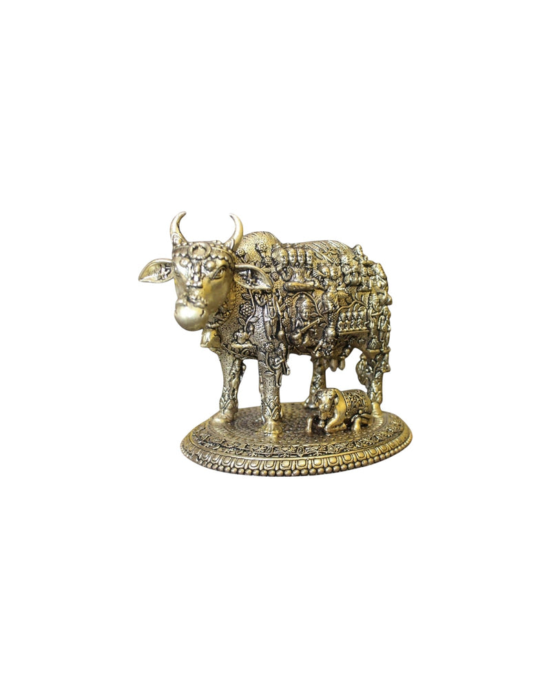Rigvedaa™ brass Kamdhenu cow and calf idol with intricate engravings of Hindu gods, symbolizing prosperity and divine blessings.