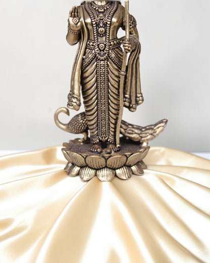 Rigvedaa brass idol of Lord Kartikeya holding a spear, standing on a lotus with peacocks. Ideal for pooja rooms.