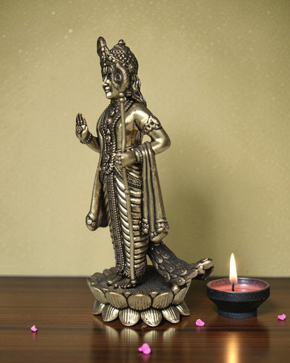 Rigvedaa brass idol of Lord Kartikeya standing on a lotus, holding a spear, with peacock feather details.