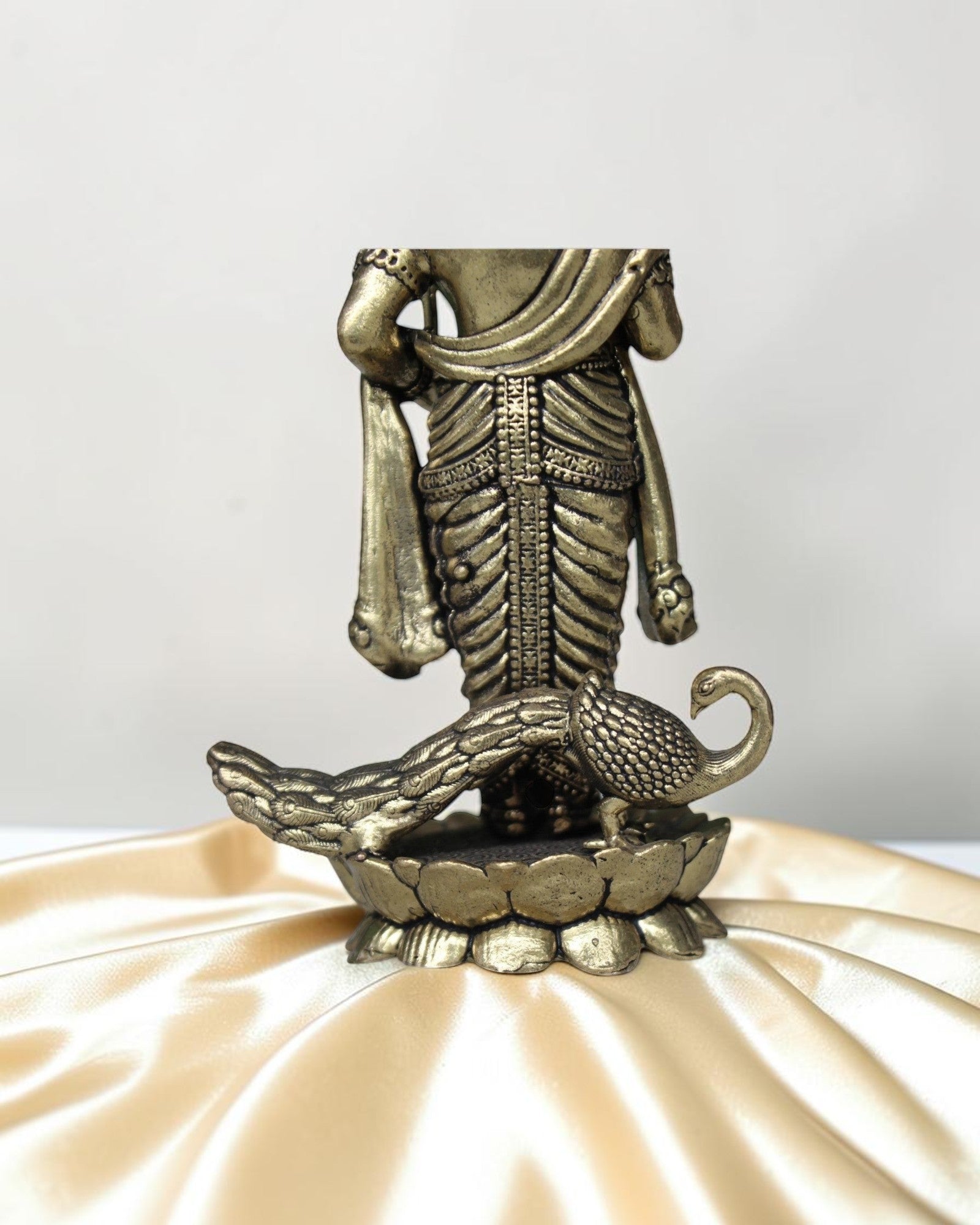 Rigvedaa brass Lord Kartikeya idol with peacock, holding spear, for pooja room and home decor.
