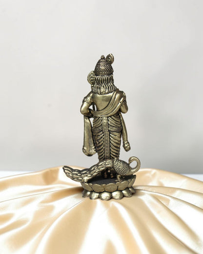 Rigvedaa brass idol of Lord Kartikeya holding a spear, with a peacock at his feet. Detailed traditional finish.