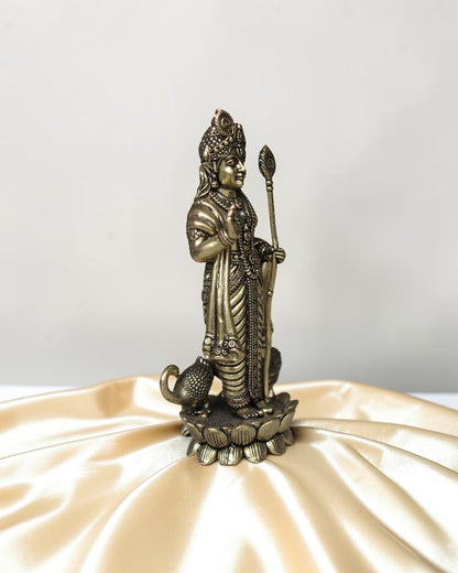Rigvedaa brass idol of Lord Kartikeya holding a spear, standing on a lotus with a peacock at his feet. Traditional Indian deity statue.
