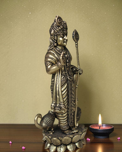 Rigvedaa brass idol of Lord Kartikeya holding a spear, standing on a lotus with a peacock at his feet. Traditional Indian deity statue.