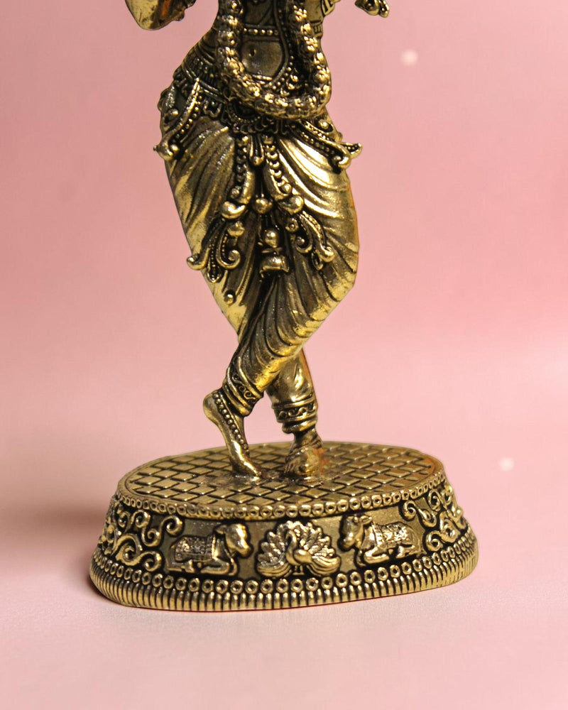 Rigvedaa
™ Handcrafted brass statue of Lord Krishna playing the flute, with intricate detailing on attire and base.