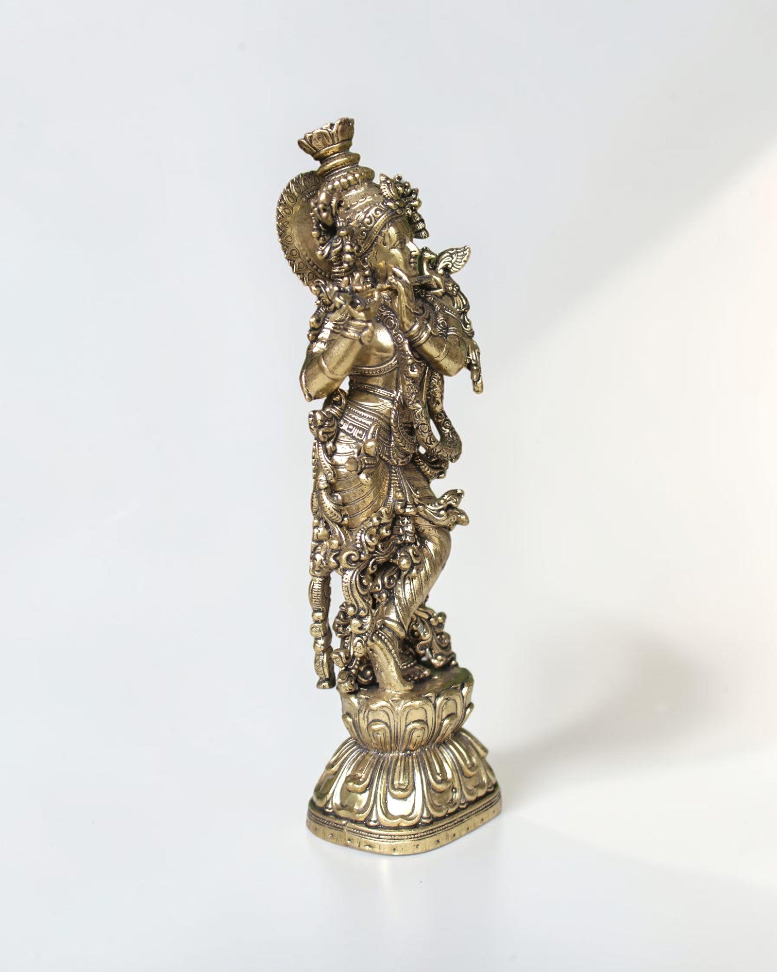 Rigvedaa™ brass Krishna idol with flute, 7.5 inch, standing in Tribhanga pose with peacock crown, golden finish.