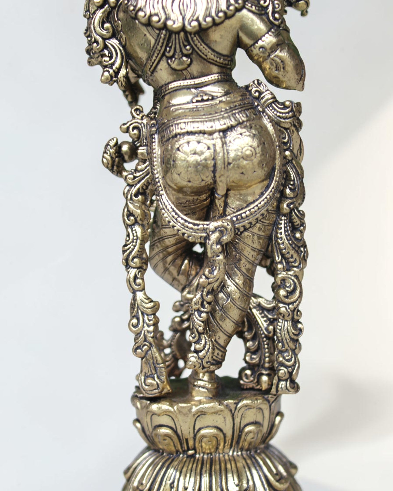 Rigvedaa brass Krishna idol with flute, 7.5 inch, in Tribhanga pose with peacock crown, golden finish.