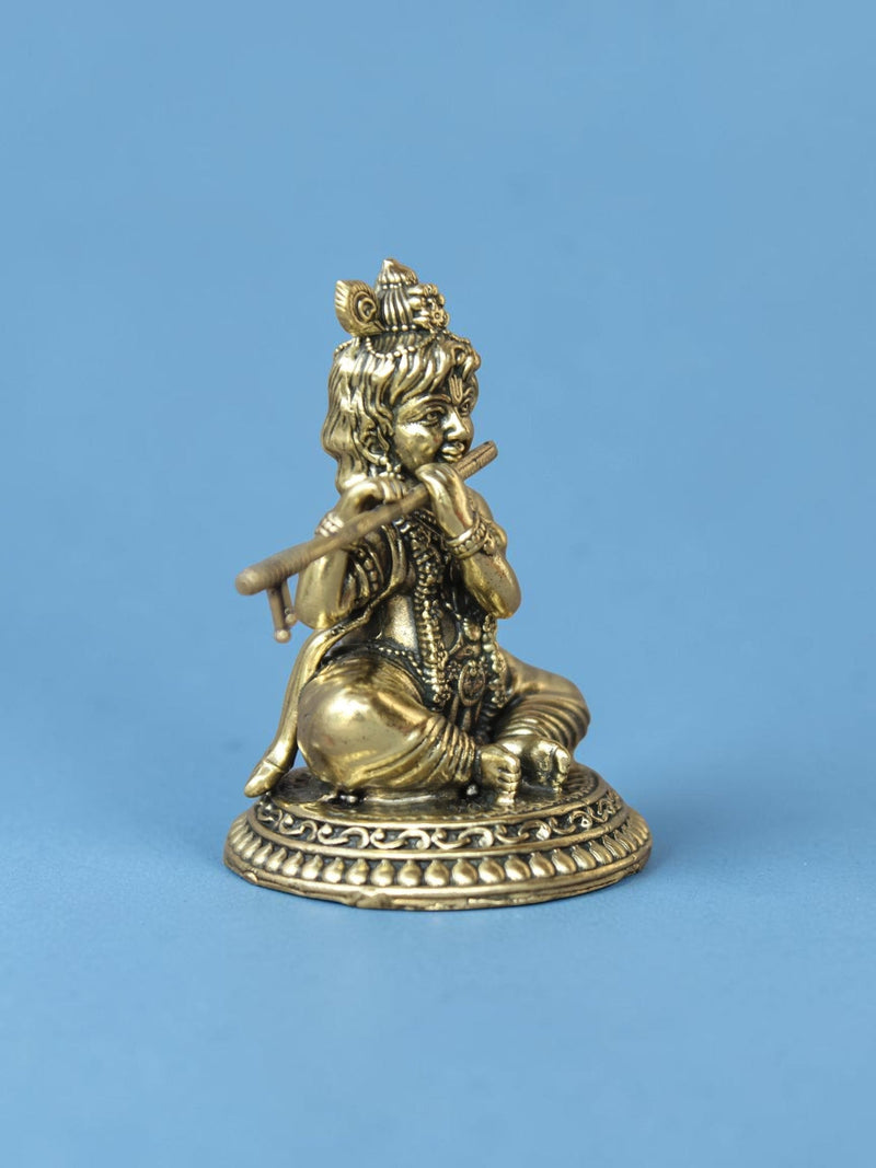 Rigvedaa™ handcrafted brass Laddu Gopal idol featuring Lord Krishna playing a flute with an ornate peacock crown