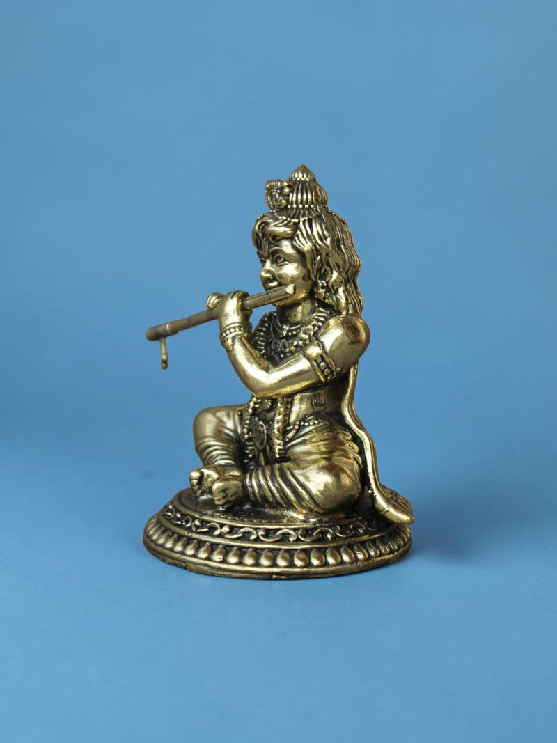 Rigvedaa™ brass Laddu Gopal idol featuring Lord Krishna playing a flute with an ornate crown and antique golden finish.