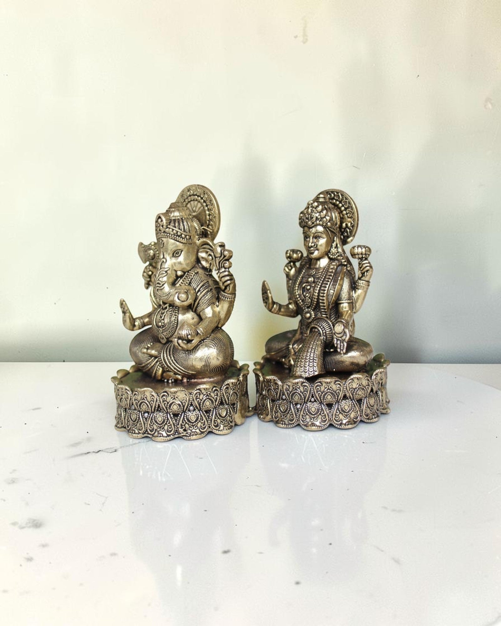 Rigvedaa brass Lakshmi Ganesh idol on lotus base, intricate detailing, golden finish, for wealth and wisdom.