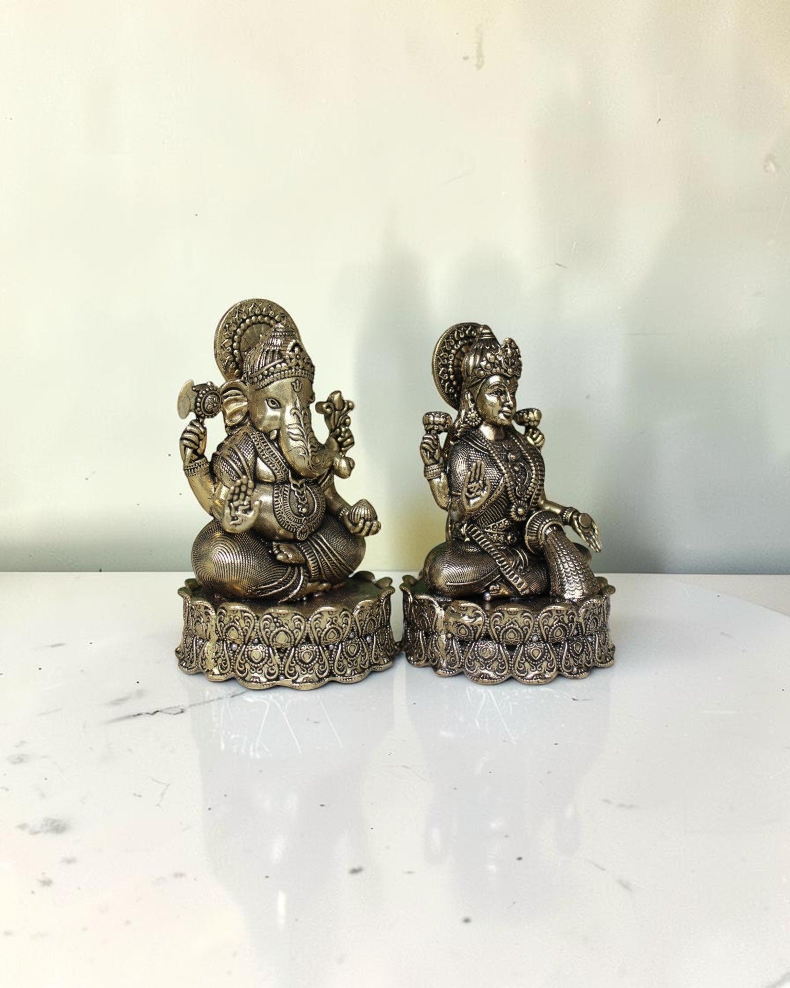 Rigvedaa™ brass Lakshmi Ganesh idol on lotus base, detailed antique gold finish, for wealth and wisdom.