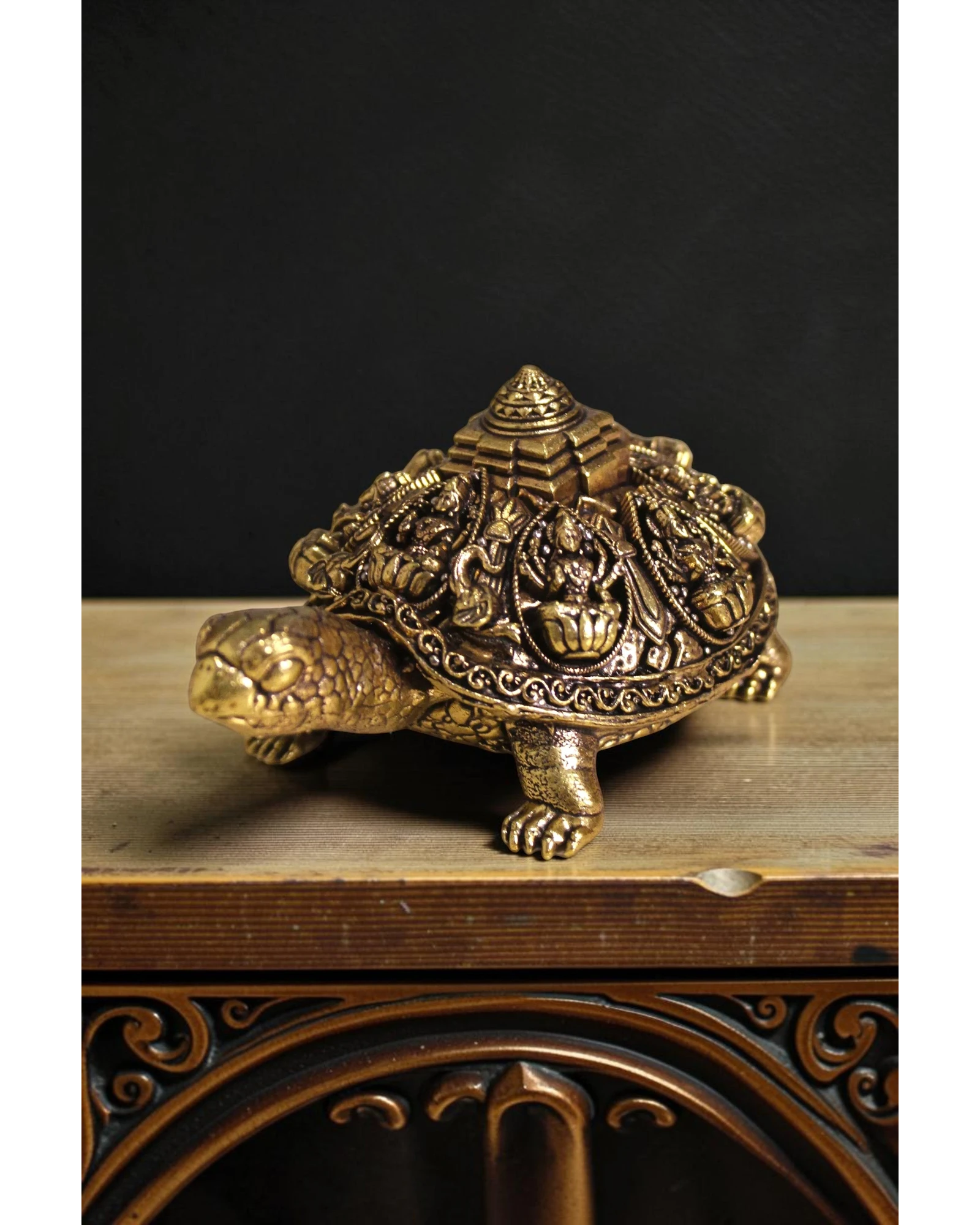 Rigvedaa™ golden brass tortoise figurine with intricate Ashta Lakshmi figures and Shree Yantra engraving on its shell, representing prosperity and good fortune.