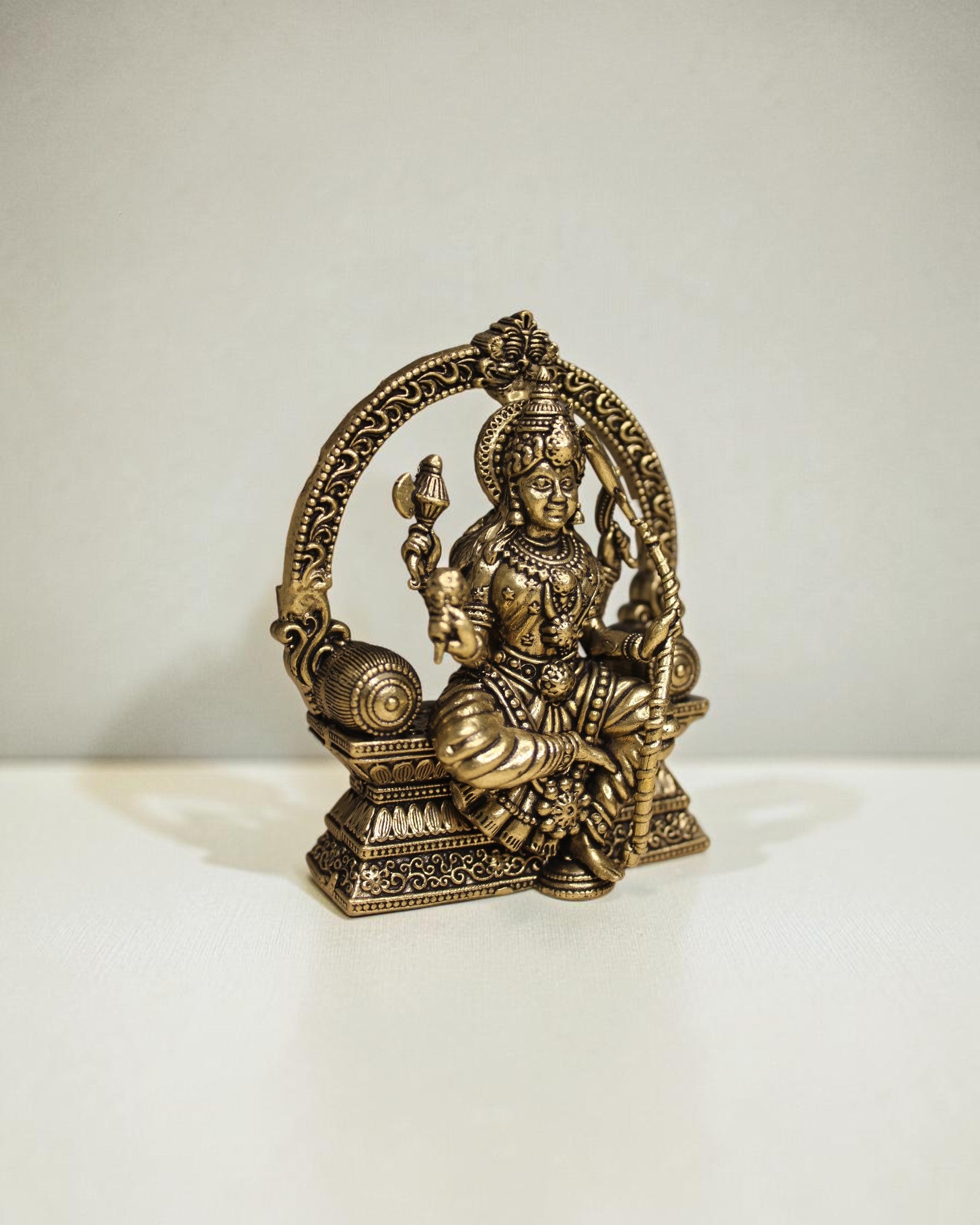 Rigvedaa™ Brass Lalitha Tripura Sundari Devi idol, 4-inch, golden patina, intricate traditional relief work, seated posture, holding divine objects.