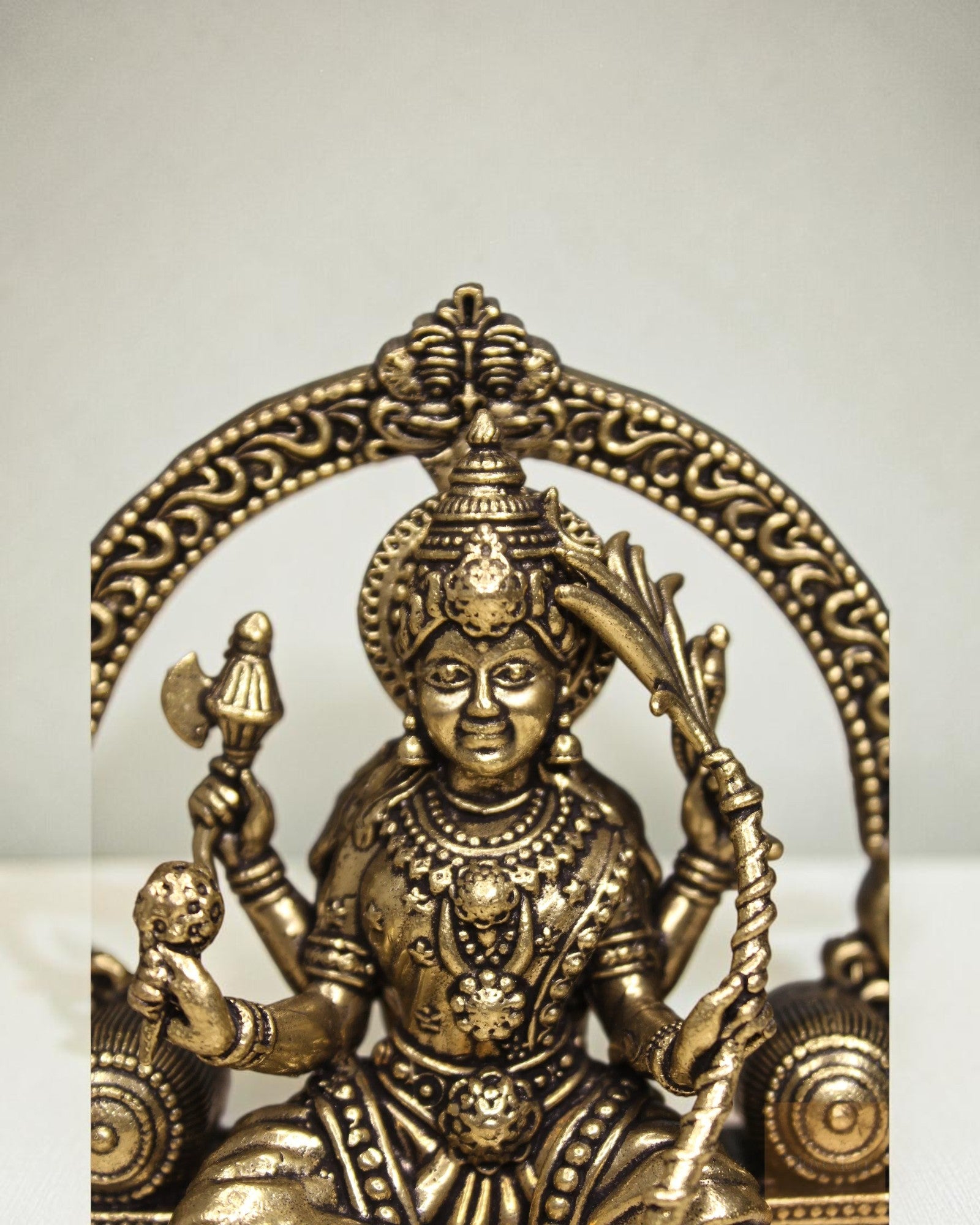 Rigvedaa™ Brass Lalitha Tripura Sundari Devi idol, 4-inch, golden patina, intricate traditional relief work, holding axe and bow.