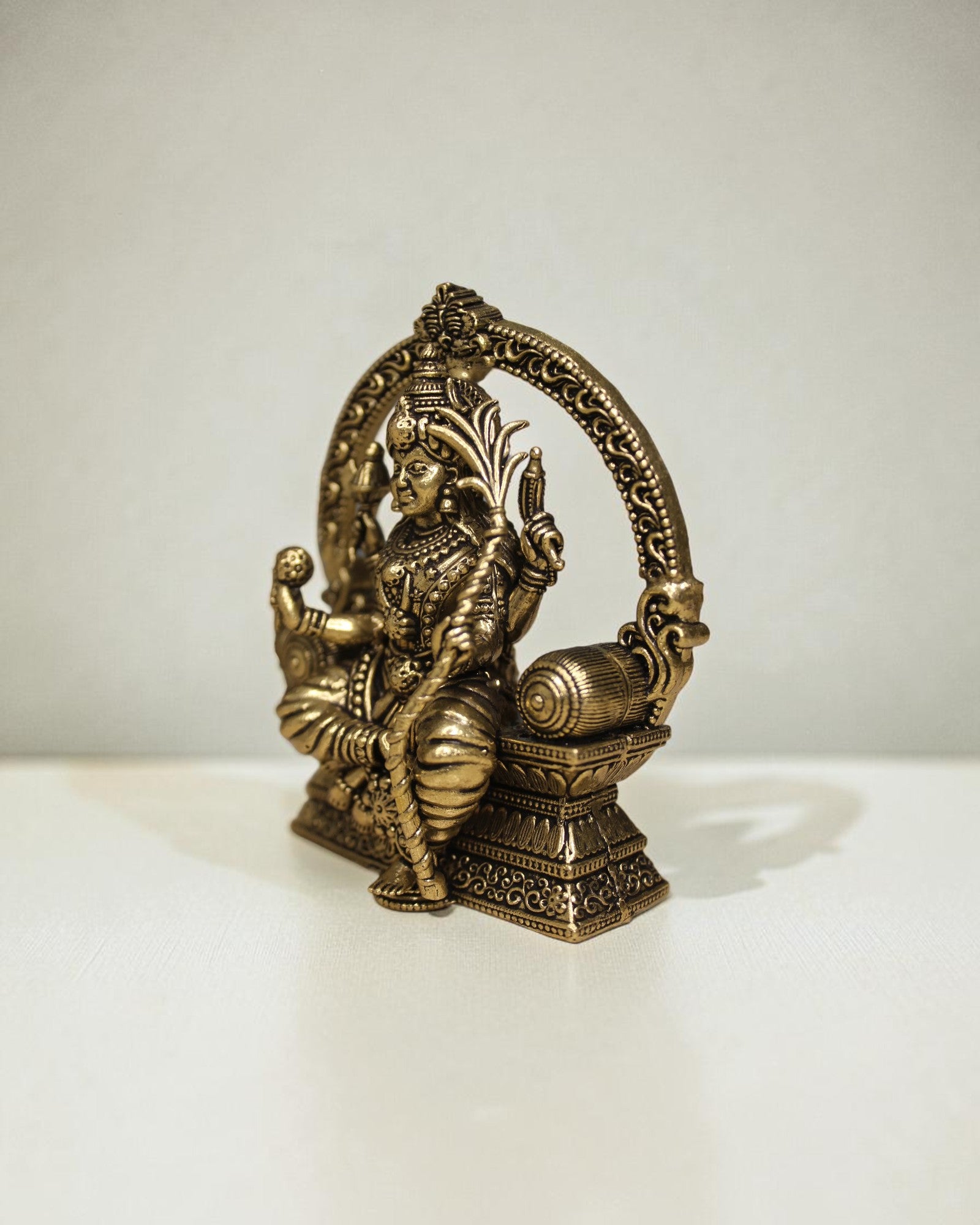 Rigvedaa™ Brass Lalitha Tripura Sundari Devi idol, 4-inch, golden patina, intricate traditional relief work, seated posture.