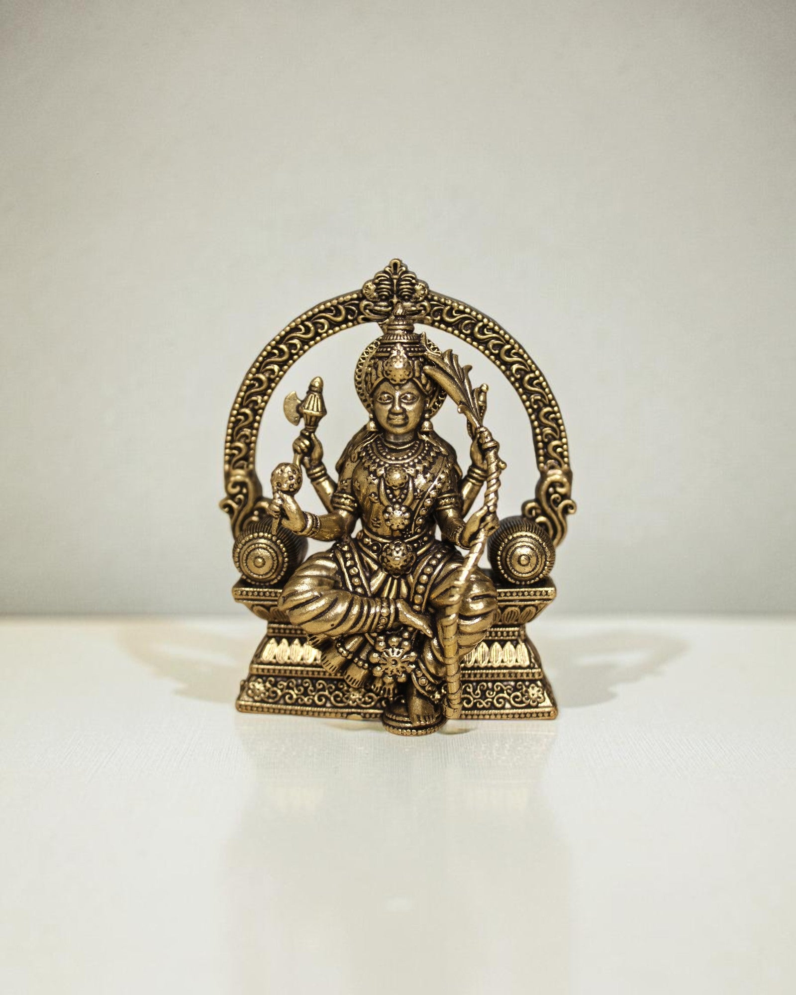 Rigvedaa™ Brass Lalitha Tripura Sundari Devi idol, 4-inch, golden patina, intricate traditional relief work, seated posture, holding divine weapons.
