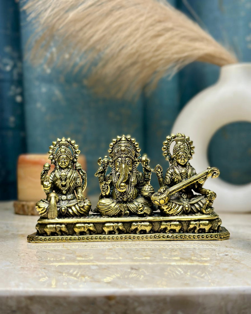 Rigvedaa Brass Laxmi Ganesh Saraswati idol set, golden patina, intricate traditional details, 3-inch height, for home or office mandir.