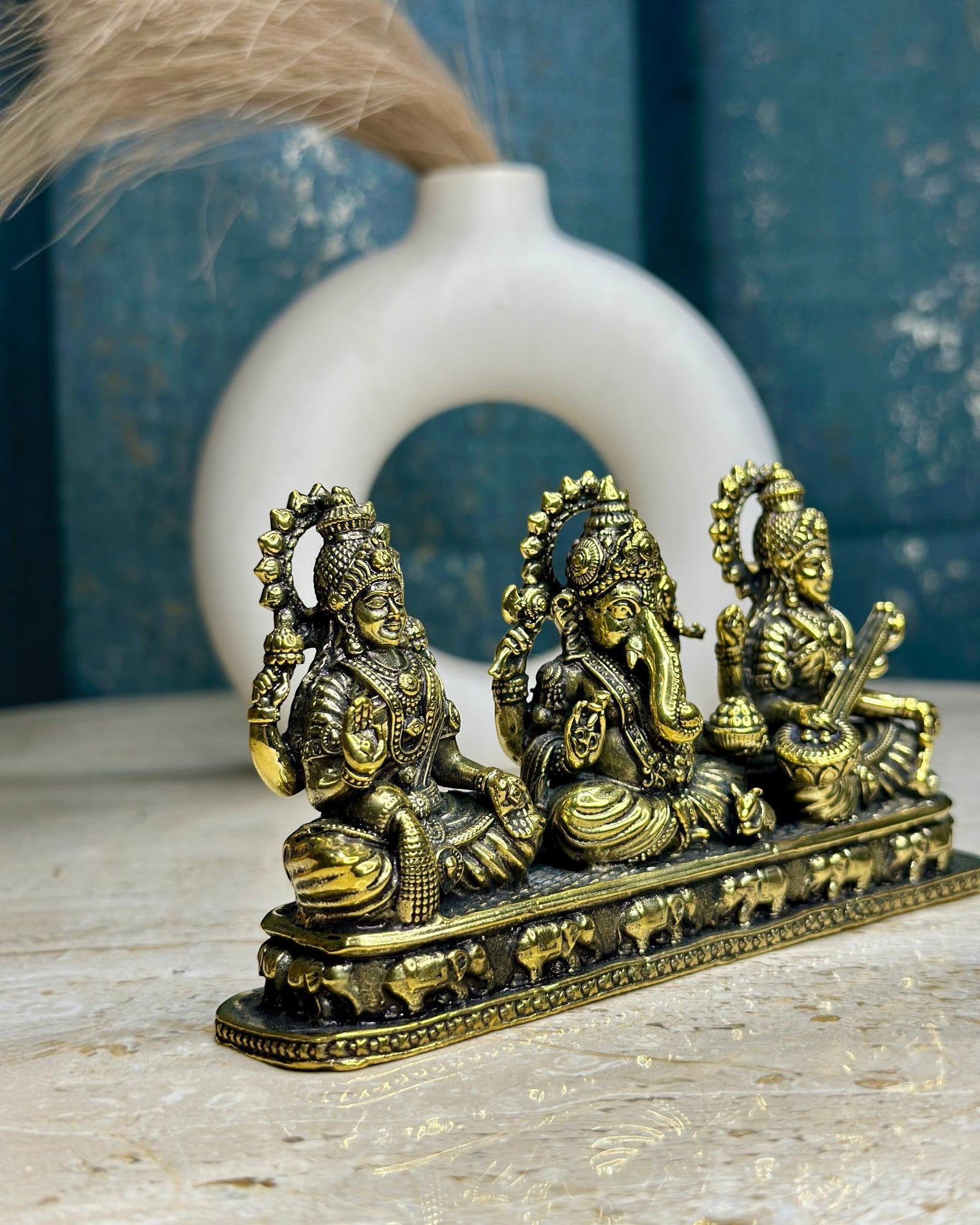 Rigvedaa

Brass Laxmi Ganesh Saraswati idol set, golden patina, intricate details, for home or office altar.