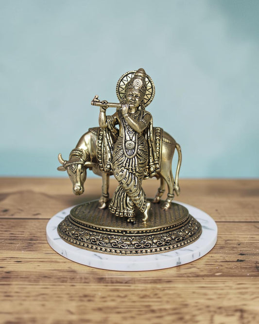 Rigvedaa™ Brass Lord Krishna playing flute with cow statue, 5 inch, golden patina, intricate details, Vastu compliant.