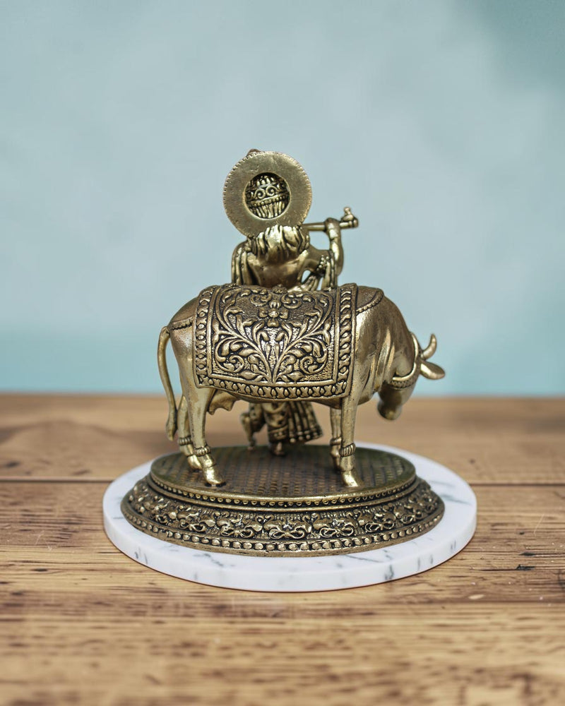 Rigvedaa™ Brass Lord Krishna playing flute with a cow, intricate details, 5-inch Vastu statue.