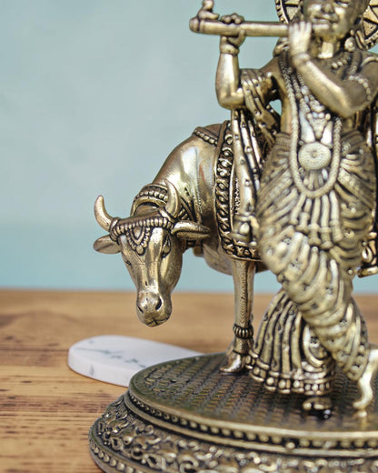Rigvedaa™ Brass Lord Krishna with Cow Vastu Statue, 5-inch, golden patina, intricate details, spiritual decor.
