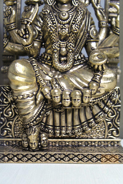 Rigvedaa™ 6-inch brass idol of Goddess Mariamman seated, adorned with jewelry and multiple arms. Features intricate details and a golden finish.