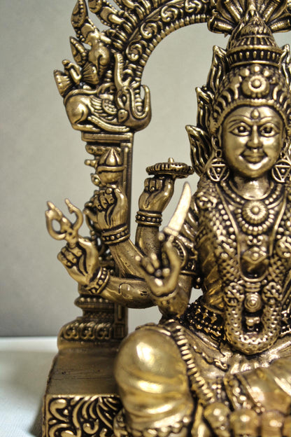Rigvedaa™ brass idol of Goddess Mariamman, 6-inch, seated, holding trident and knife, adorned with jewelry.