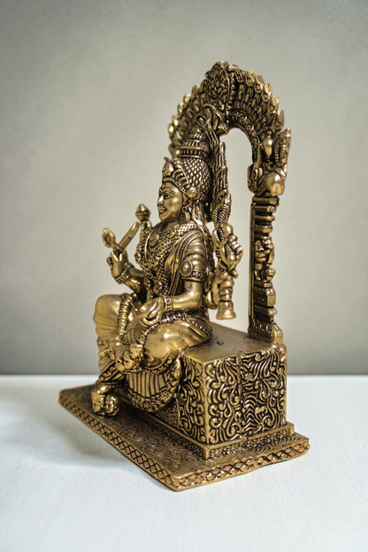 Rigvedaa™ brass idol of Goddess Mariamman seated, adorned with jewelry, holding a weapon. 6-inch statue for home worship.