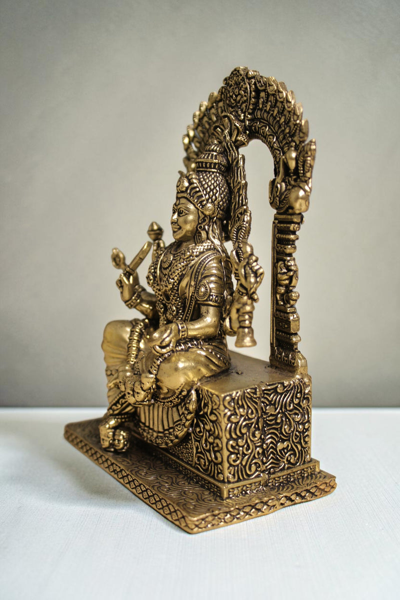 Rigvedaa™ brass idol of Goddess Mariamman seated, adorned with jewelry, holding a weapon. 6-inch statue for home worship.