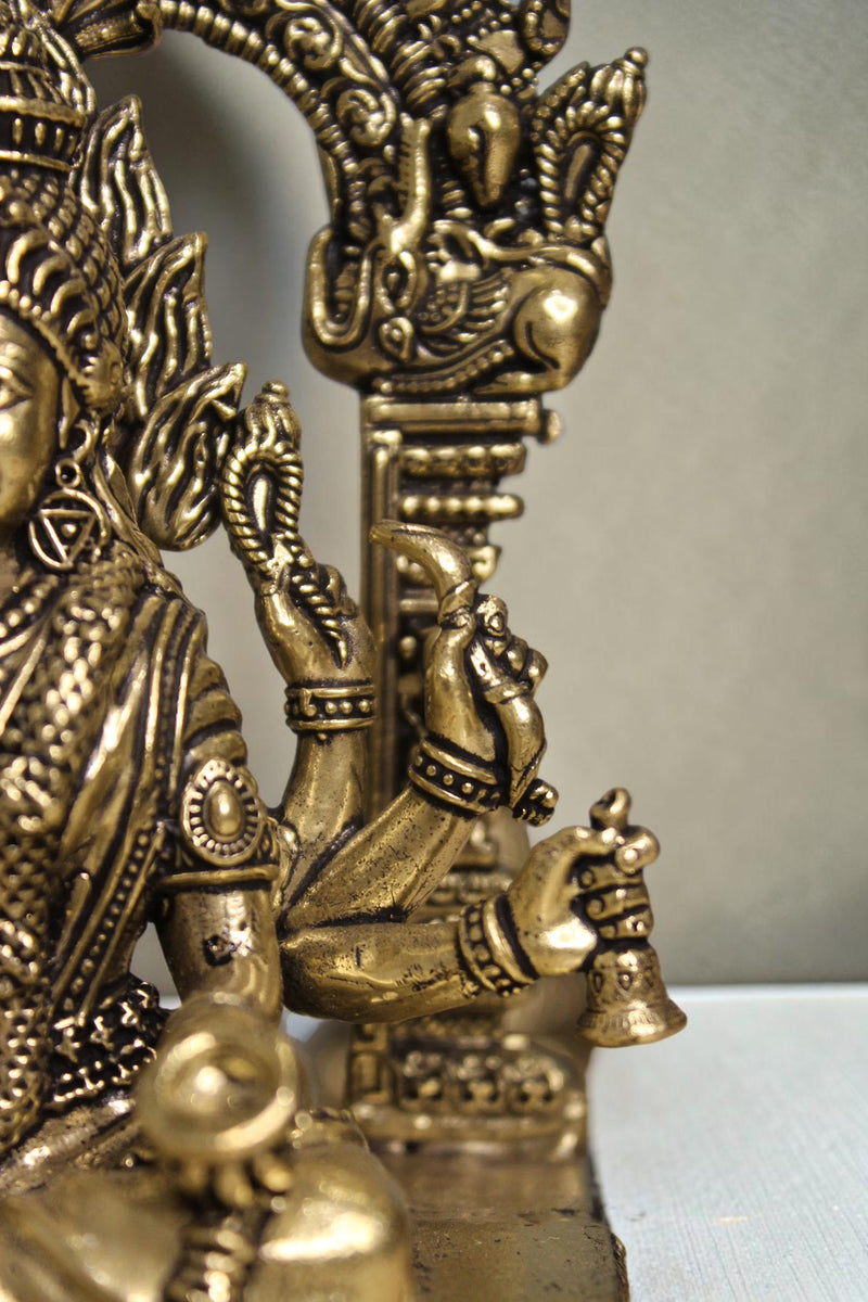 Rigvedaa™ brass idol of Goddess Mariamman, 6-inch, seated, holding a bell, adorned with ornaments.
