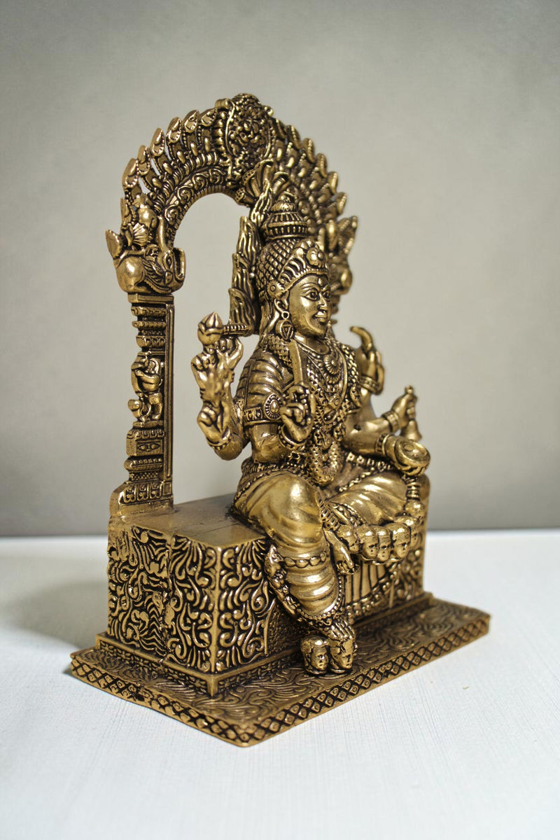 Rigvedaa™ brass idol of Goddess Mariamman seated with ornate headdress and intricate details, 6 inches tall.